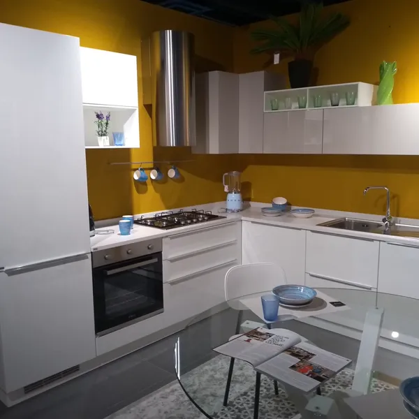 Cucina ad angolo bianca lucida showroom con parete gialla